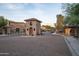 Elegant gated community entrance with stone guard house and manicured landscaping at 5641 E Grovers Ave, Scottsdale, AZ 85254