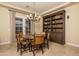 Cozy dining room features a stylish chandelier and beautiful built-in bookcase at 5641 E Grovers Ave, Scottsdale, AZ 85254