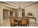 This dining room features a wood table, beautiful chandelier, and decorative accents at 5641 E Grovers Ave, Scottsdale, AZ 85254