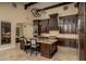 Open kitchen with island, seating, custom cabinets, and modern appliances at 5641 E Grovers Ave, Scottsdale, AZ 85254