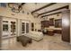 Spacious living room with travertine floors, beamed ceilings and French doors at 5641 E Grovers Ave, Scottsdale, AZ 85254