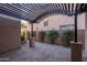 Charming patio with brick pavers, pergola, and landscaped border, perfect for outdoor relaxation at 5641 E Grovers Ave, Scottsdale, AZ 85254