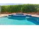 Sparkling pool and spa surrounded by lush green hedges for privacy at 5641 E Grovers Ave, Scottsdale, AZ 85254