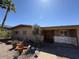 Charming single-story home with desert landscaping and stone accents, complemented by a lush palm tree in the front yard at 5829 E Windsor Ave, Scottsdale, AZ 85257