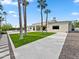 Spacious backyard featuring lush lawn, palm trees, and a stone paver patio at 6129 E Turquoise Ave, Paradise Valley, AZ 85253