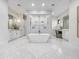 Beautiful bathroom boasting a modern tub, marble floors, walk-in shower, and dual vanities at 6129 E Turquoise Ave, Paradise Valley, AZ 85253