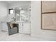Bathroom vanity area featuring white cabinets, marble countertops, and decorative lighting at 6129 E Turquoise Ave, Paradise Valley, AZ 85253