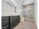 Bathroom with black vanity and tiled walk-in shower at 6129 E Turquoise Ave, Paradise Valley, AZ 85253