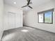 Bright bedroom features a ceiling fan, window with blinds, and closet with sliding doors at 6129 E Turquoise Ave, Paradise Valley, AZ 85253