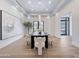 Elegant dining room featuring modern chandelier, tray ceiling, and view of exterior at 6129 E Turquoise Ave, Paradise Valley, AZ 85253
