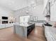 Open-concept living space flows into a well-equipped kitchen with a large island and modern lighting at 6129 E Turquoise Ave, Paradise Valley, AZ 85253