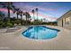 Backyard pool and patio with lounge chairs and palm trees against a colorful sky at 6129 E Turquoise Ave, Paradise Valley, AZ 85253