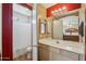 Bathroom featuring a functional vanity with a bright mirror and an enclosed shower with a clean, white curtain at 7329 W Lamar Rd, Glendale, AZ 85303