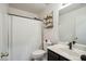 Functional bathroom featuring a sleek vanity and an enclosed shower with a clean, white curtain at 7329 W Lamar Rd, Glendale, AZ 85303
