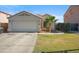 Single-Gathering home featuring a large garage, desert landscaping, and a charming palm tree at 7329 W Lamar Rd, Glendale, AZ 85303