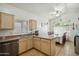 Bright kitchen featuring ample counter space, a center island, stainless steel appliances, and a dining area at 7329 W Lamar Rd, Glendale, AZ 85303