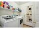 Well-equipped laundry room with modern washer and dryer units, plus convenient shoe storage for organization at 7329 W Lamar Rd, Glendale, AZ 85303