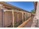 Backyard garden featuring an attractive wooden cage with an easy to maintain desert landscape at 7589 W Quail Track Dr, Peoria, AZ 85383