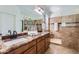 Bathroom featuring double vanity, granite counters, tile flooring, and walk-in shower at 7589 W Quail Track Dr, Peoria, AZ 85383