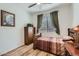 Bedroom featuring laminate flooring, a large window, and wood furniture at 7589 W Quail Track Dr, Peoria, AZ 85383