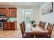 Dining room showcasing a large table with seating for eight, connecting the kitchen and living area at 7589 W Quail Track Dr, Peoria, AZ 85383