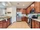 Bright kitchen boasts stainless steel appliances, granite countertops, and abundant storage at 7589 W Quail Track Dr, Peoria, AZ 85383