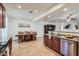 Open-concept design with modern kitchen featuring granite countertops, tile flooring, and stainless appliances at 7589 W Quail Track Dr, Peoria, AZ 85383