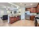 Open kitchen showcasing granite countertops, stainless steel appliances, and seamless flow to living area at 7589 W Quail Track Dr, Peoria, AZ 85383