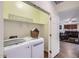 Convenient laundry room features modern appliances, built-in shelving, and easy access to the living area at 7589 W Quail Track Dr, Peoria, AZ 85383