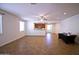 Inviting living room featuring tile flooring, a ceiling fan, and lots of natural light at 7589 W Quail Track Dr, Peoria, AZ 85383