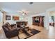 Spacious living room with open access to the kitchen and dining area, with a warm and inviting atmosphere at 7589 W Quail Track Dr, Peoria, AZ 85383