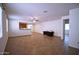 Bright, open-concept living room with neutral tile flooring and easy access to the kitchen at 7589 W Quail Track Dr, Peoria, AZ 85383