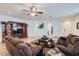 Inviting living room with comfortable furniture, entertainment center, and a warm color palette at 7589 W Quail Track Dr, Peoria, AZ 85383