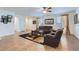 Bright living room featuring neutral walls, tile flooring, and stylish window coverings at 7589 W Quail Track Dr, Peoria, AZ 85383
