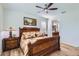 Comfortable main bedroom with a ceiling fan and an ensuite bathroom with granite countertops at 7589 W Quail Track Dr, Peoria, AZ 85383