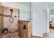 Elegant walk-in shower featuring brown tile, decorative accents, and a convenient shower bench at 7589 W Quail Track Dr, Peoria, AZ 85383