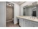 Bathroom features a vanity with drawers and a large mirror, as well as a shower with patterned walls at 7843 E Valley View Rd, Scottsdale, AZ 85250