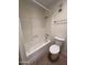 Bathroom featuring a shower-tub combo, toilet, exhaust fan and modern fixtures at 7843 E Valley View Rd, Scottsdale, AZ 85250