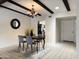 Dining room featuring modern light fixture and views to the kitchen and entry hall at 7843 E Valley View Rd, Scottsdale, AZ 85250