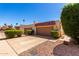Low angle shot of modern condos with two-car garages, tiled roofs, and desert landscaping under a bright blue sky at 7843 E Valley View Rd, Scottsdale, AZ 85250