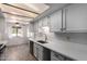 Bright kitchen with white cabinets, stainless steel appliances, light countertops, and an open layout to the dining area at 7843 E Valley View Rd, Scottsdale, AZ 85250