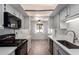 Bright modern kitchen featuring white cabinets, stainless steel appliances, and views to the dining area at 7843 E Valley View Rd, Scottsdale, AZ 85250