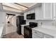 Modern kitchen featuring white cabinets, stainless steel appliances, stylish lighting, and plenty of counter space at 7843 E Valley View Rd, Scottsdale, AZ 85250