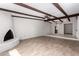 Spacious living room featuring wood-look floors, fireplace, high ceilings with wood beams, and an open-concept design at 7843 E Valley View Rd, Scottsdale, AZ 85250