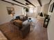 Inviting living room features beamed ceilings, a unique fireplace, and comfortable seating at 7843 E Valley View Rd, Scottsdale, AZ 85250