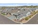 A lovely aerial view showcasing the house, neighborhood, desert landscaping, and the surrounding mountain views at 8154 E Jaeger St, Mesa, AZ 85207