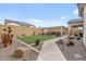 Sprawling backyard with turf, desert landscaping, stone pathway, and outdoor kitchen area at 8154 E Jaeger St, Mesa, AZ 85207