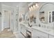 Modern bathroom with double vanity, glass shower, and round mirrors at 8154 E Jaeger St, Mesa, AZ 85207
