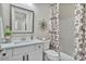 Bathroom with modern vanity, decorative mirror, and a shower with a floral curtain at 8154 E Jaeger St, Mesa, AZ 85207