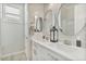 Bright bathroom features double sinks, modern fixtures, and oval mirrors at 8154 E Jaeger St, Mesa, AZ 85207